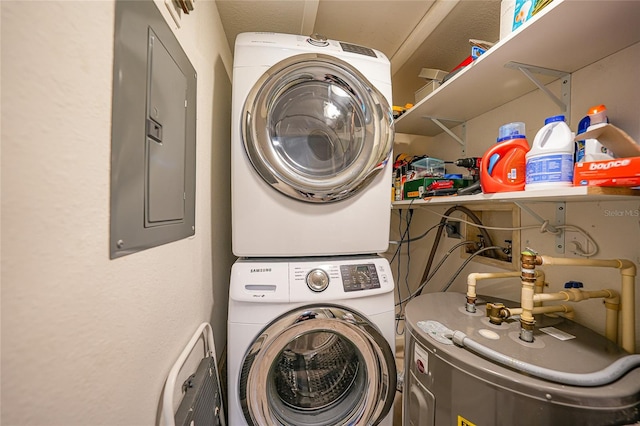 laundry area with electric panel and stacked washing maching and dryer