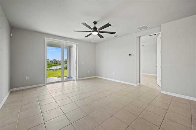 tiled empty room with ceiling fan