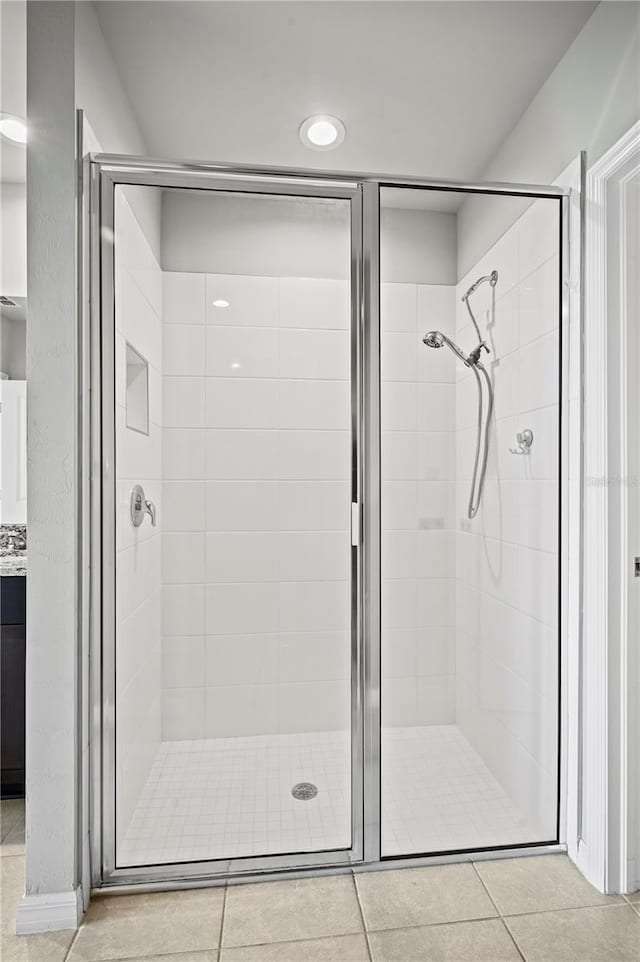 bathroom with walk in shower and tile patterned floors