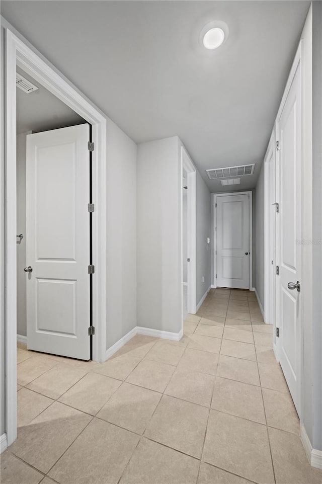 hallway with light tile patterned floors