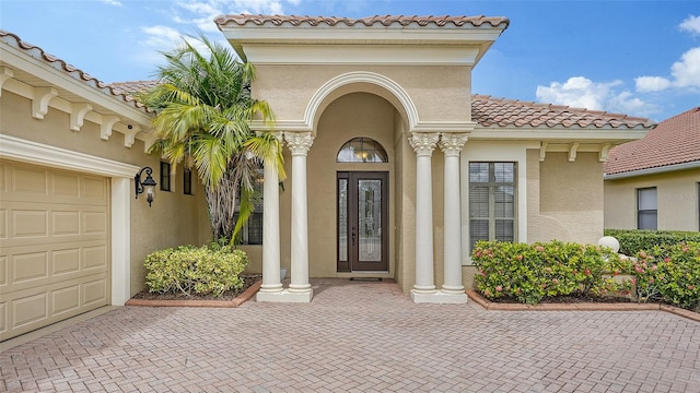 view of exterior entry with a garage