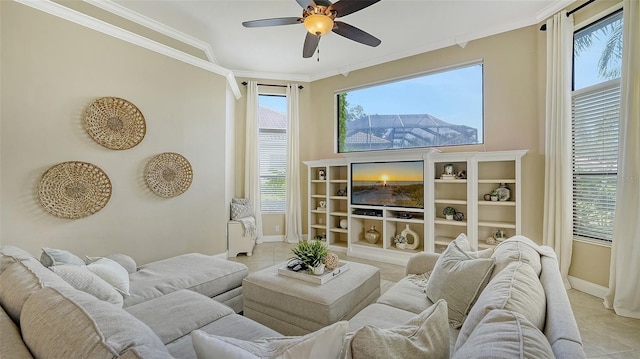 living room with a healthy amount of sunlight, crown molding, and ceiling fan