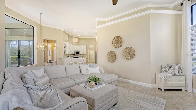 living room with ceiling fan with notable chandelier, ornamental molding, and light tile patterned floors