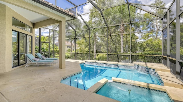 view of swimming pool with glass enclosure, an in ground hot tub, and a patio area