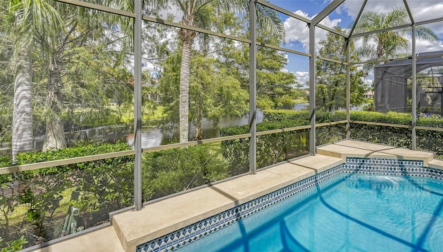 view of swimming pool featuring a lanai