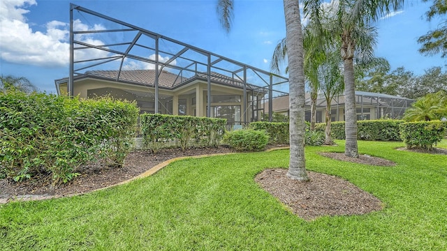 view of yard with glass enclosure