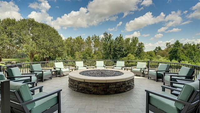 view of patio featuring an outdoor living space with a fire pit