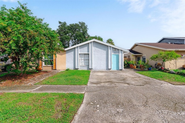 view of front of property with a front lawn and a garage