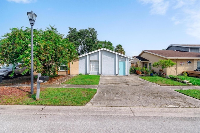 view of front of house featuring a garage and a front lawn