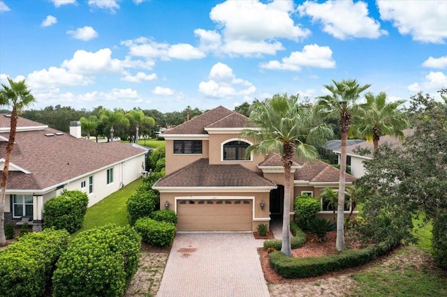 mediterranean / spanish-style home with a garage