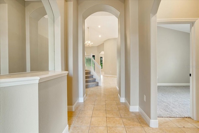 hall featuring an inviting chandelier and light tile patterned flooring