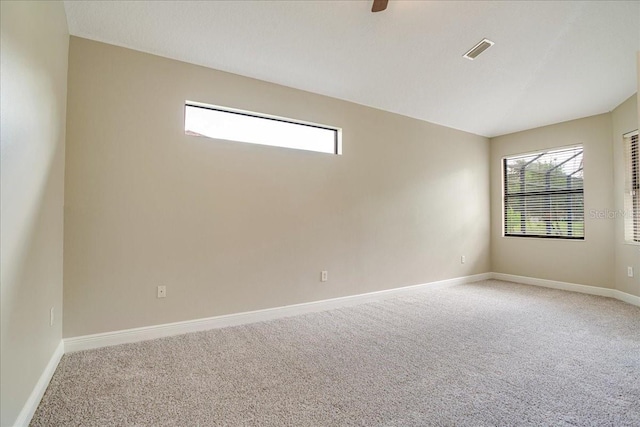 unfurnished room with ceiling fan and carpet flooring