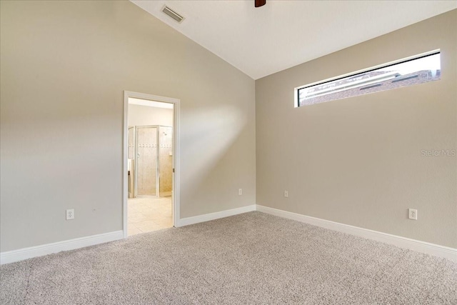 carpeted empty room with lofted ceiling and ceiling fan