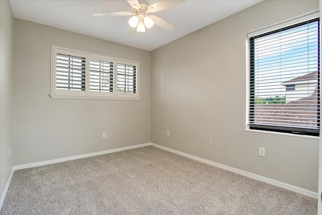 unfurnished room with ceiling fan and light colored carpet