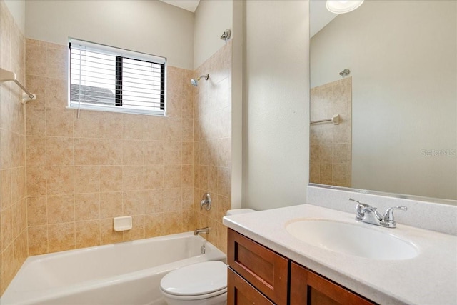 full bathroom with vanity, tiled shower / bath combo, and toilet