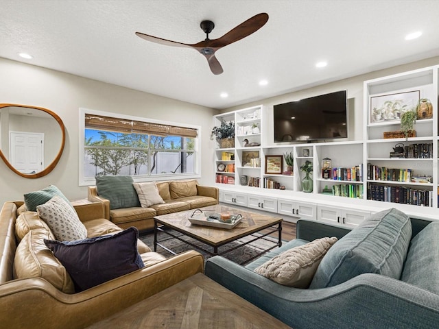 living room featuring parquet floors, a textured ceiling, and ceiling fan