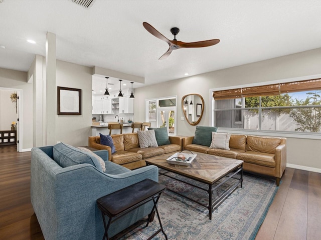 living room featuring dark hardwood / wood-style floors and ceiling fan