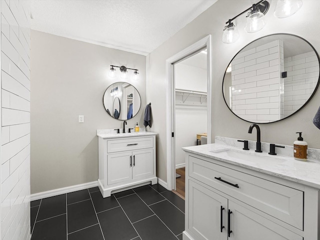 bathroom with vanity, a textured ceiling, walk in shower, and tile patterned flooring