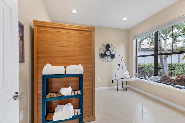 tiled bedroom featuring multiple windows