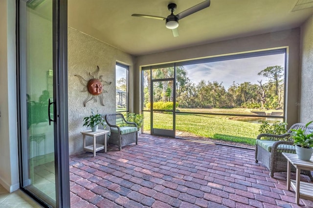 sunroom featuring ceiling fan