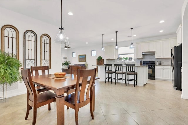 tiled dining area featuring ceiling fan