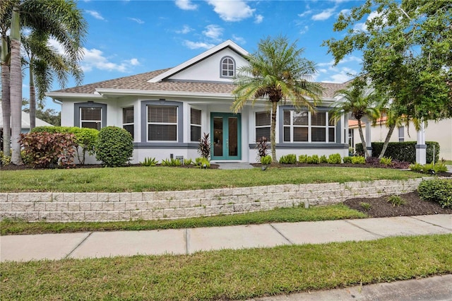 view of front of home with french doors and a front yard