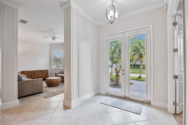 entryway with ornamental molding, a healthy amount of sunlight, and ceiling fan with notable chandelier