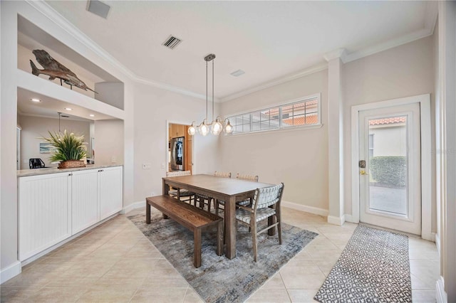 dining area featuring light tile patterned floors, an inviting chandelier, and ornamental molding