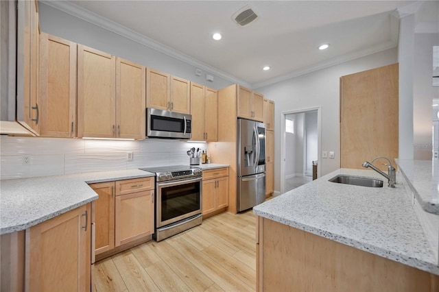 kitchen featuring light stone countertops, sink, light brown cabinetry, and appliances with stainless steel finishes