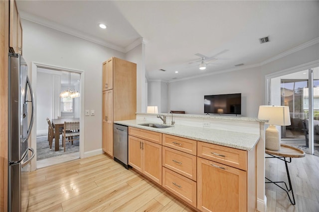 kitchen featuring light brown cabinetry, sink, kitchen peninsula, and stainless steel appliances