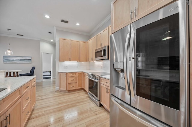 kitchen featuring appliances with stainless steel finishes, decorative light fixtures, light brown cabinets, light hardwood / wood-style floors, and ornamental molding