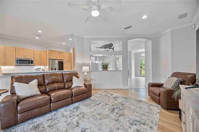 living room with ceiling fan, crown molding, and light hardwood / wood-style floors