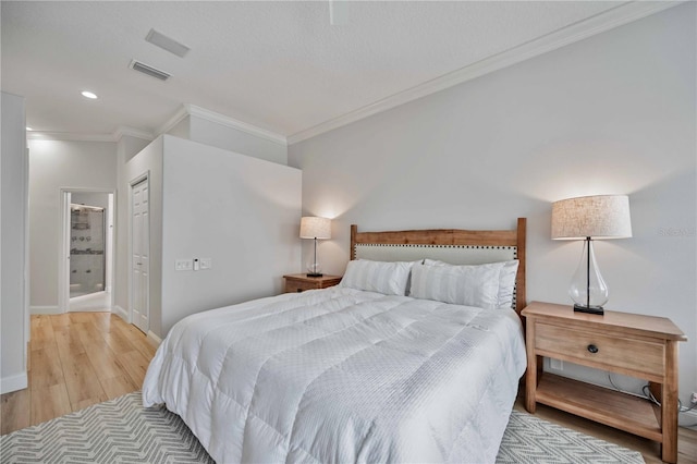 bedroom featuring a closet, ornamental molding, and light hardwood / wood-style flooring