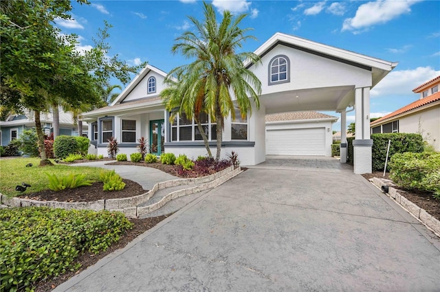 view of front of property featuring driveway, a porch, and stucco siding