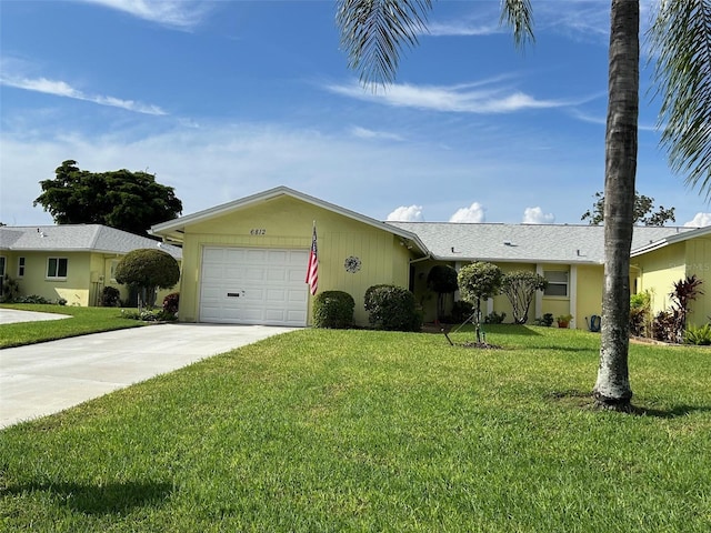 ranch-style home featuring a garage and a front yard