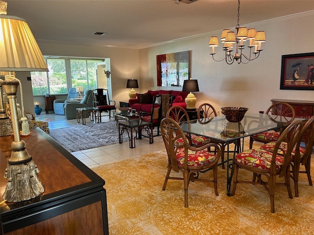 dining room featuring crown molding, a chandelier, and light tile patterned floors