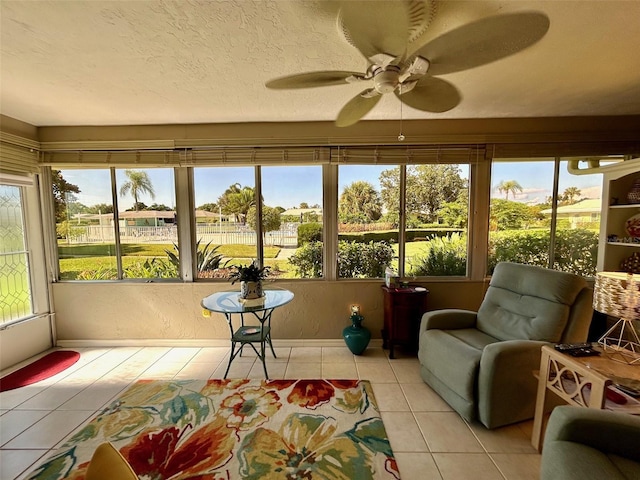 sunroom / solarium featuring plenty of natural light and ceiling fan