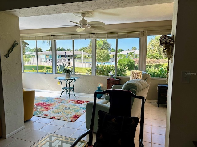 sunroom featuring ceiling fan and a wealth of natural light