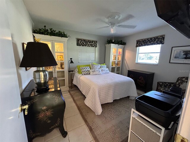 tiled bedroom with ceiling fan