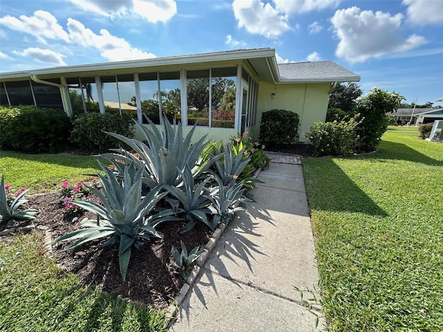 view of side of property with a lawn