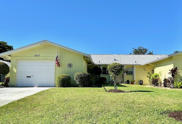 single story home featuring a garage and a front yard