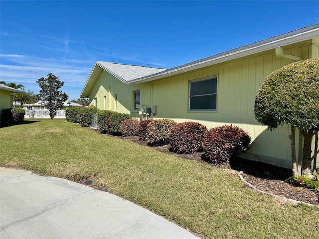 view of side of property with a yard