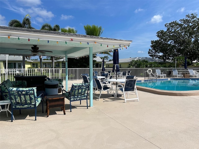 view of pool with ceiling fan and a patio