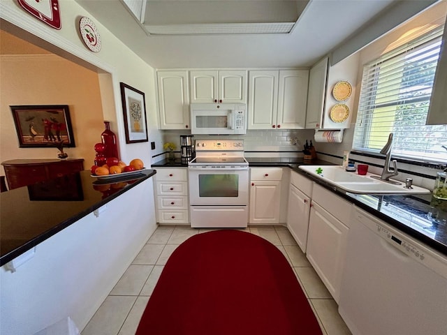 6812 11th Ave W Unit 6812, Bradenton, FL 34209 - kitchen with white appliances, white cabinetry, light tile patterned floors, and decorative backsplash