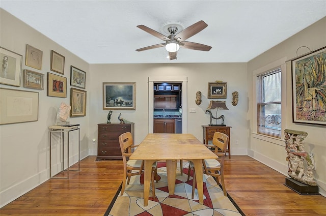 dining room with ceiling fan, sink, and hardwood / wood-style flooring