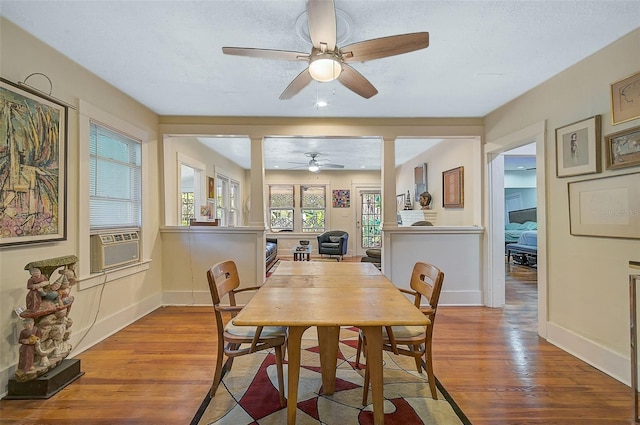 dining space with light wood-type flooring, ceiling fan, and cooling unit