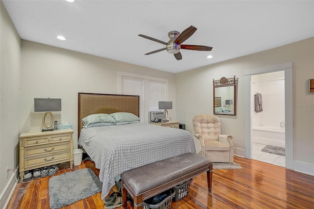 bedroom with ceiling fan, light wood-type flooring, and ensuite bathroom