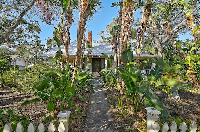 1663 4th St, Sarasota, FL 34236 - obstructed view of property featuring a chimney and metal roof