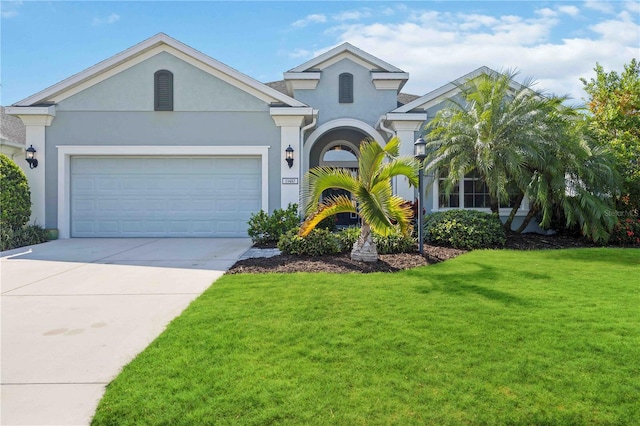 view of front of house with a front lawn and a garage