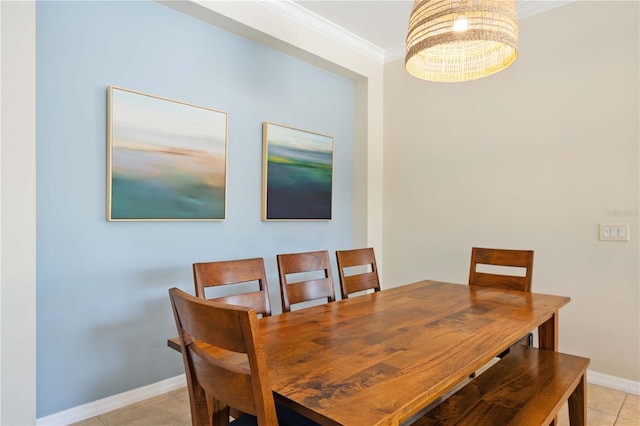 dining room with light tile patterned floors and crown molding